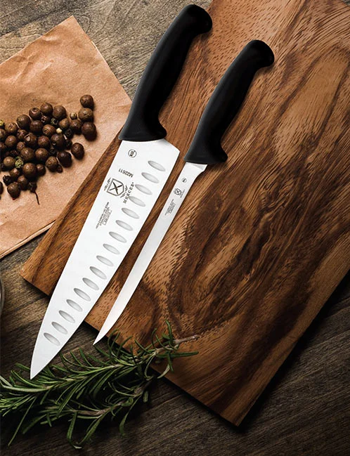 Mercer Millennia knives on a wooden board with herbs